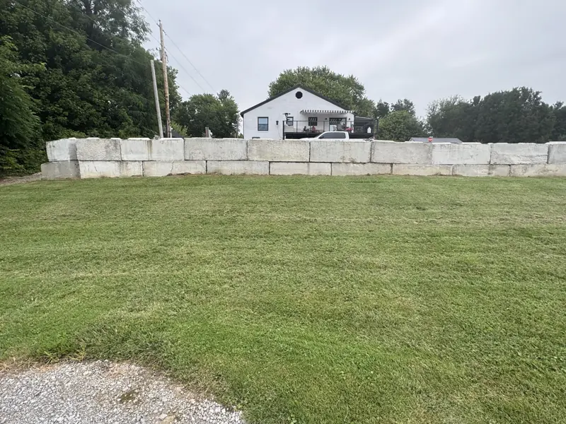 Mowed lawn with a stone block wall
