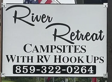 Hand-painted sign: River Retreat, campsites with RV hook ups, 859-322-0264